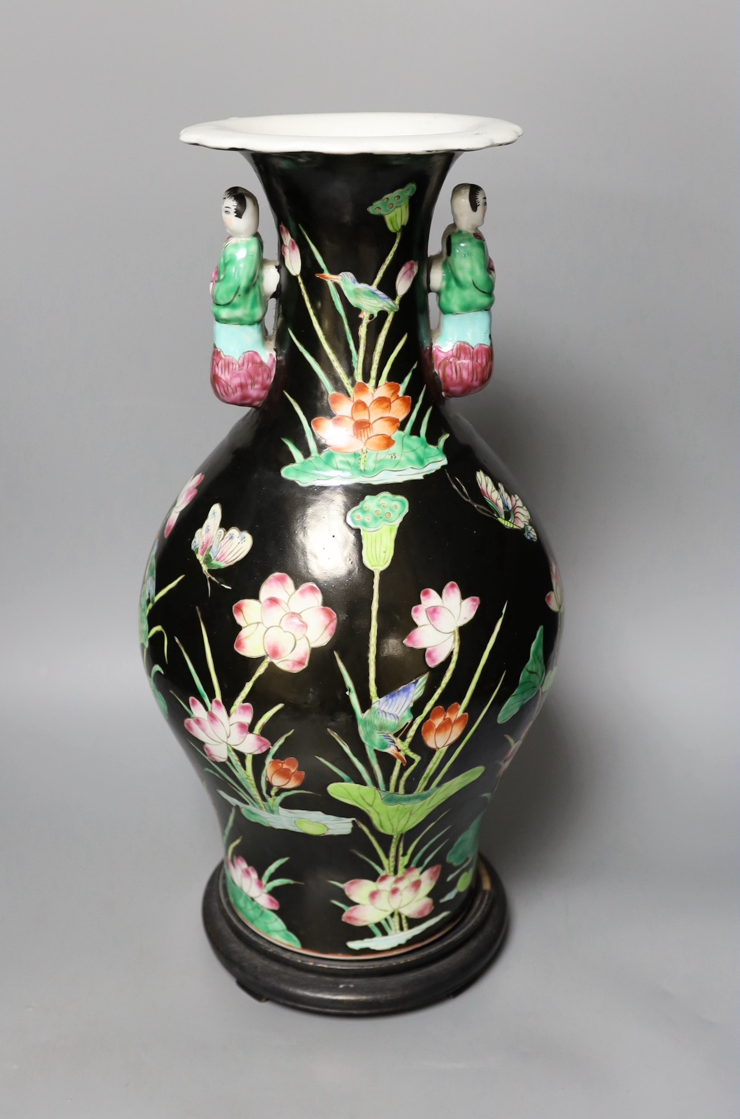 A Chinese famille noire vase, on plinth, 46 cms high